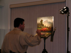 Image of artist Stefan Baumann painting. In Baumann's art classes participants are encouraged to do the painting with his assistance with occasional demonstrations