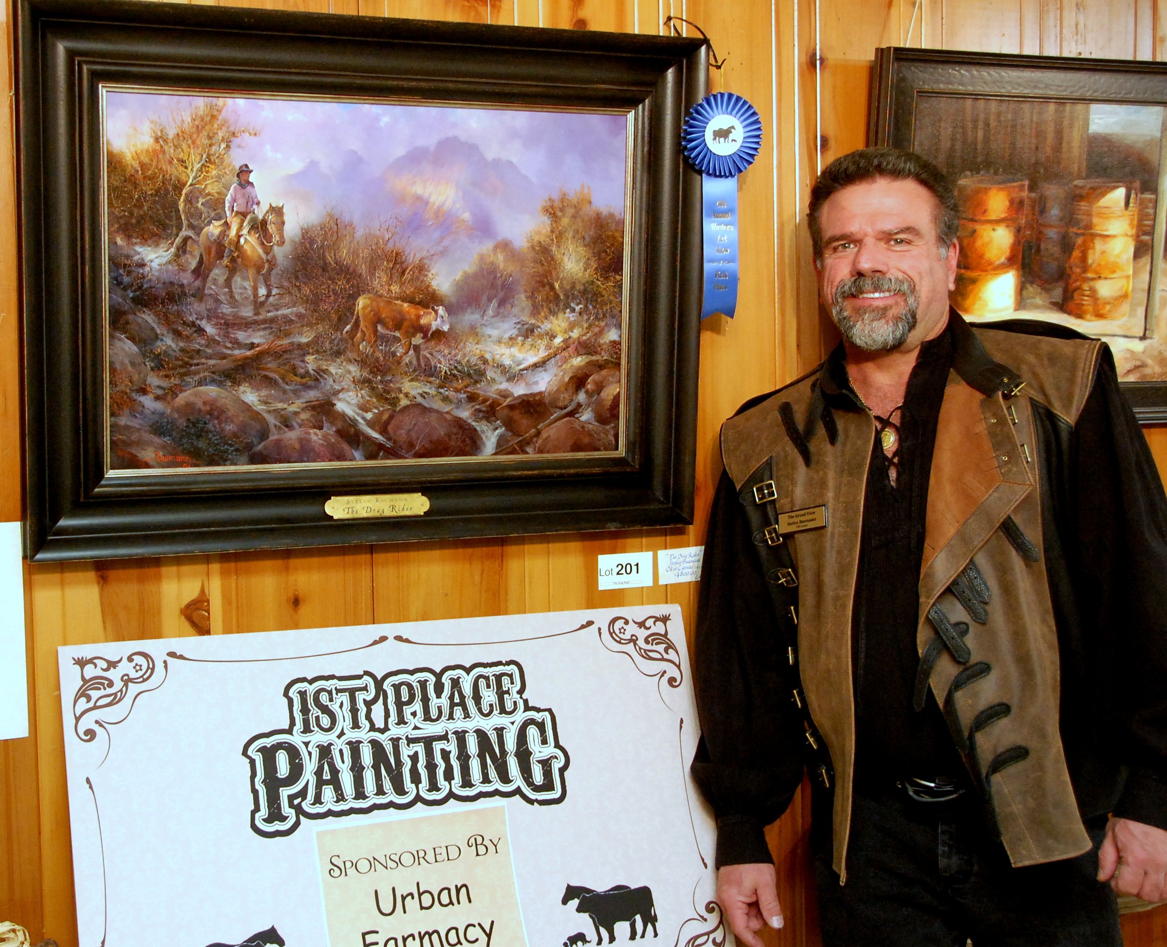 Image of artist Stefan Baumann with "The Drag Rider", first place painting at the 4th Annual Western Art Show in Red Bluff, CA, 2014.