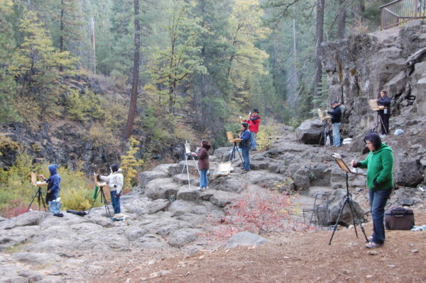 This is a photo of a Fall Workshop's participants who paint on the rocks looking down on the Lower Falls.