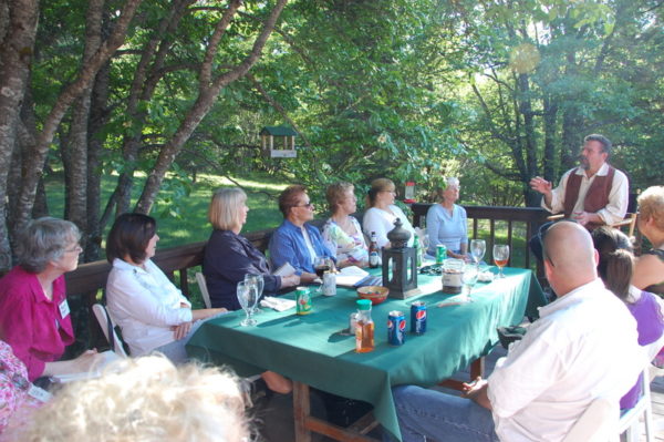 This is a photo of participants talking about the principles and techniques with Stefan Baumann during the painting Workshop at the Grand View Ranch.