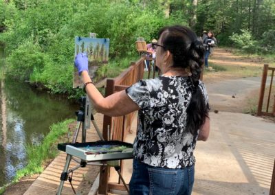 Workshop participant paints at The Grand View Ranch