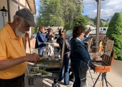 Workshop participants paint at a nearby location